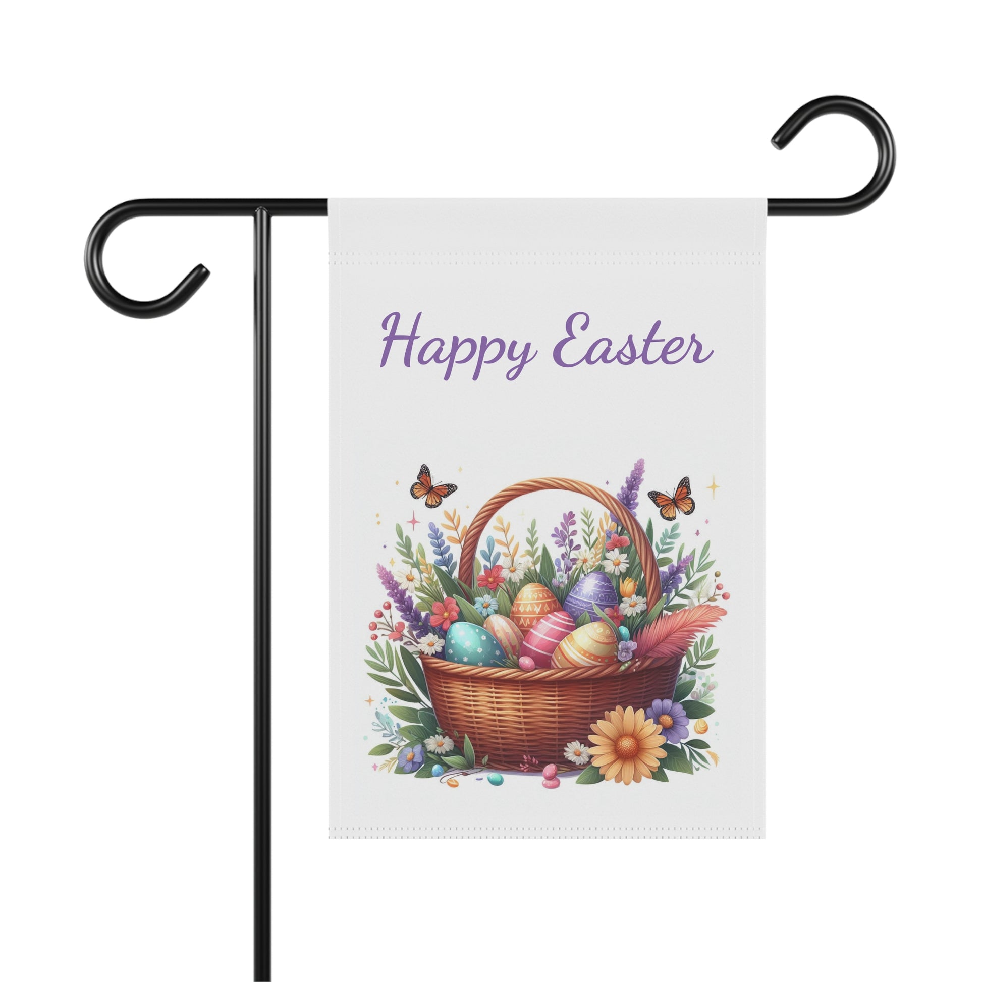 "Vertical white garden flag displaying 'Happy Easter' in purple script above a detailed illustration of a brown woven basket filled with painted Easter eggs, purple lavender, pink and yellow wildflowers, and green foliage, with two orange butterflies, shown on a black metal garden flag holder."