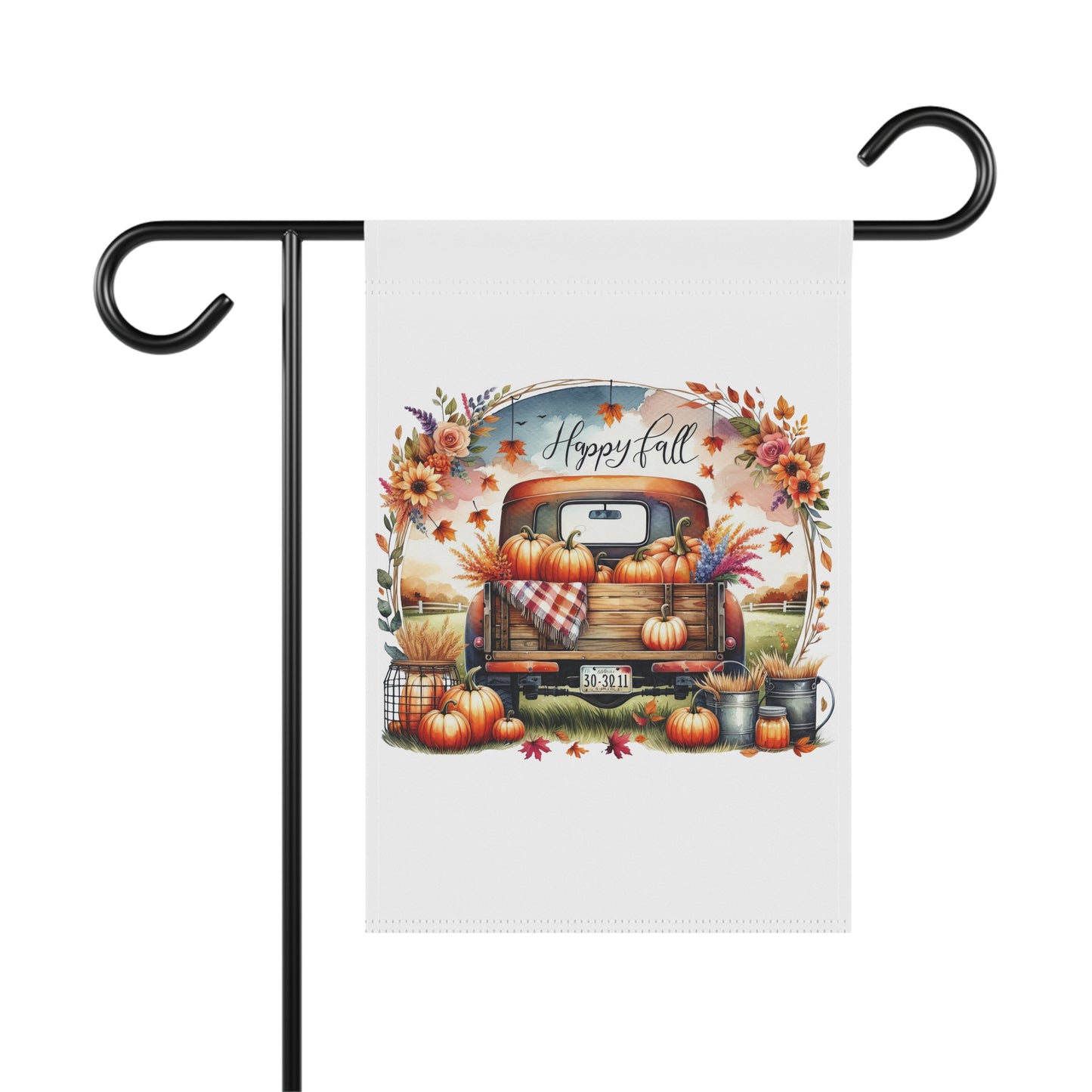 White garden flag with a vintage orange pickup truck full of pumpkins and fall flowers, surrounded by an autumn floral wreath, with "Happy Fall" script above. Additional pumpkins and fall decor are at the base of the truck.