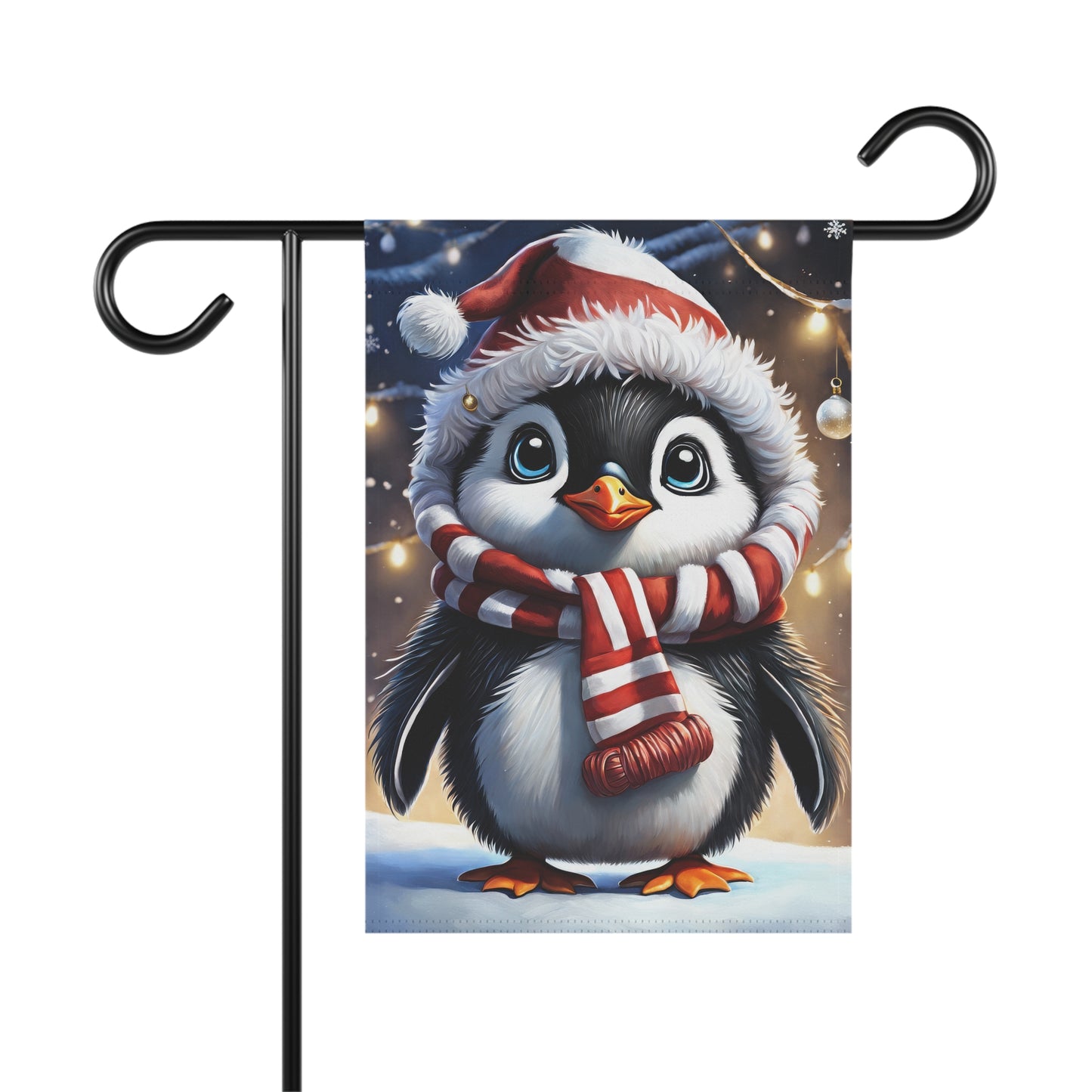 Adorable baby Christmas penguin garden flag wearing a Santa hat and a red and white striped scarf, in a snowy scene with blurred holiday lights, on a black metal garden flag stand