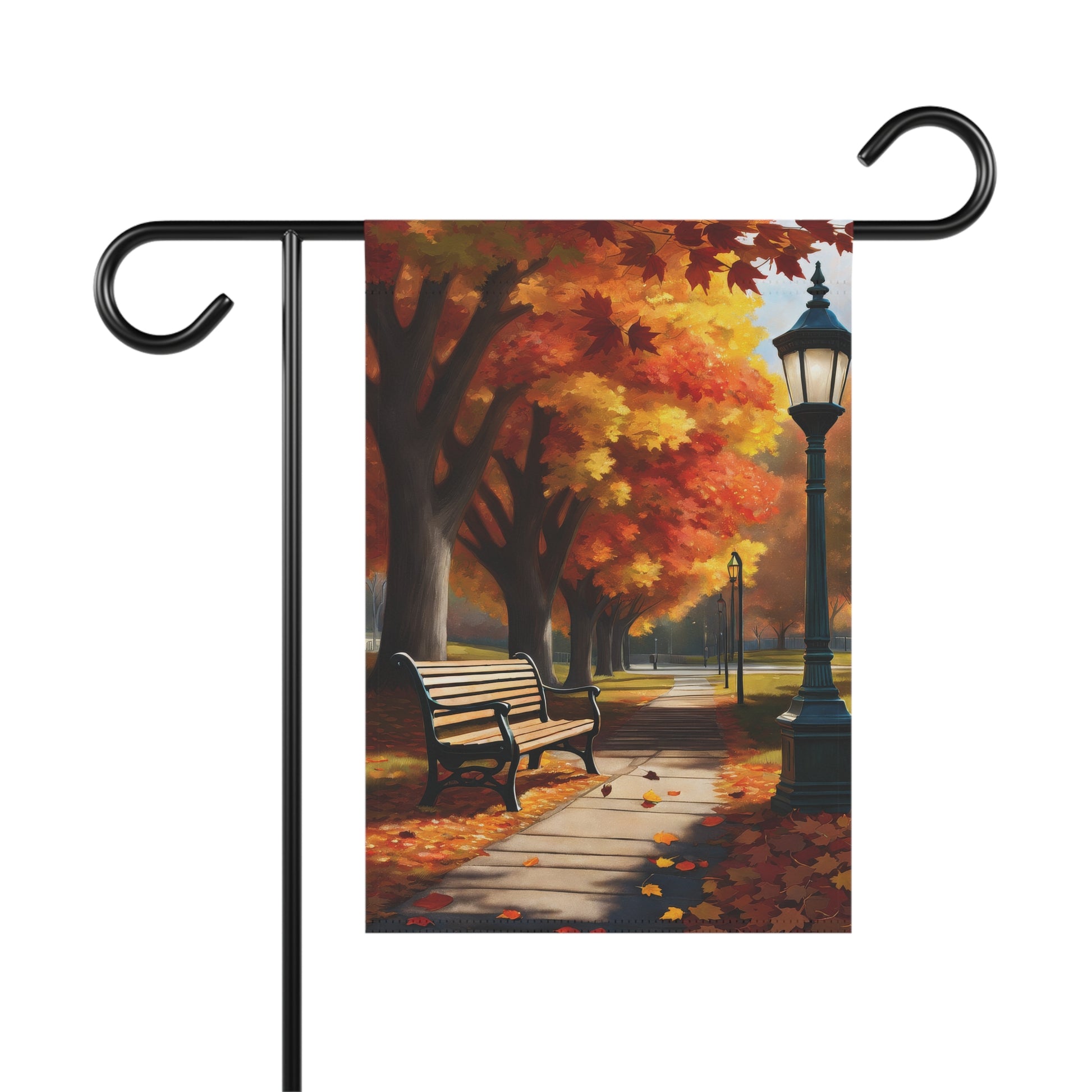 Garden flag depicting a vibrant autumn park scene with a path, orange and yellow fall trees, a street light, and a park bench with fallen leaves.