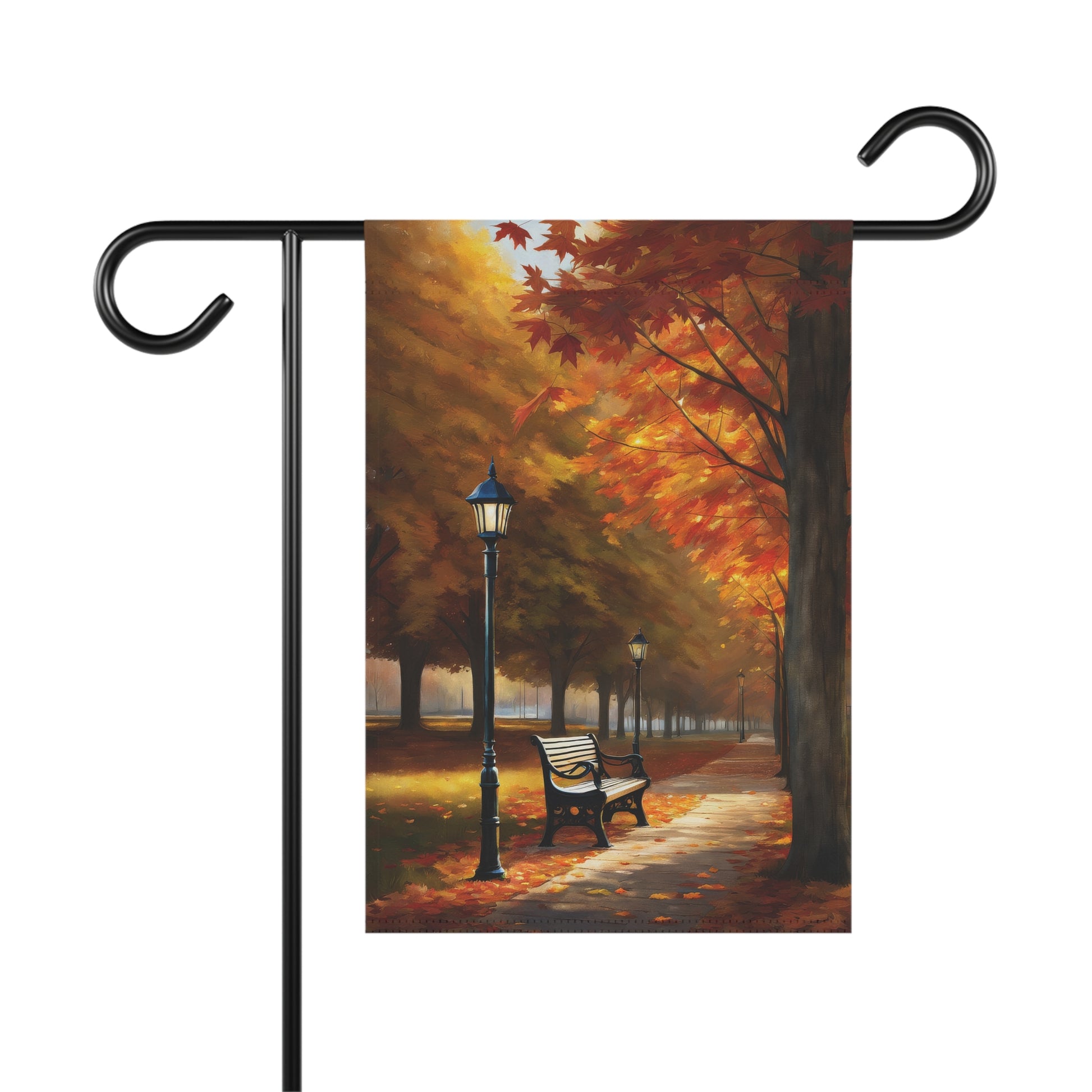 Garden flag showing a vibrant autumn park lane with bright orange and red fall trees, a streetlight, and a park bench.