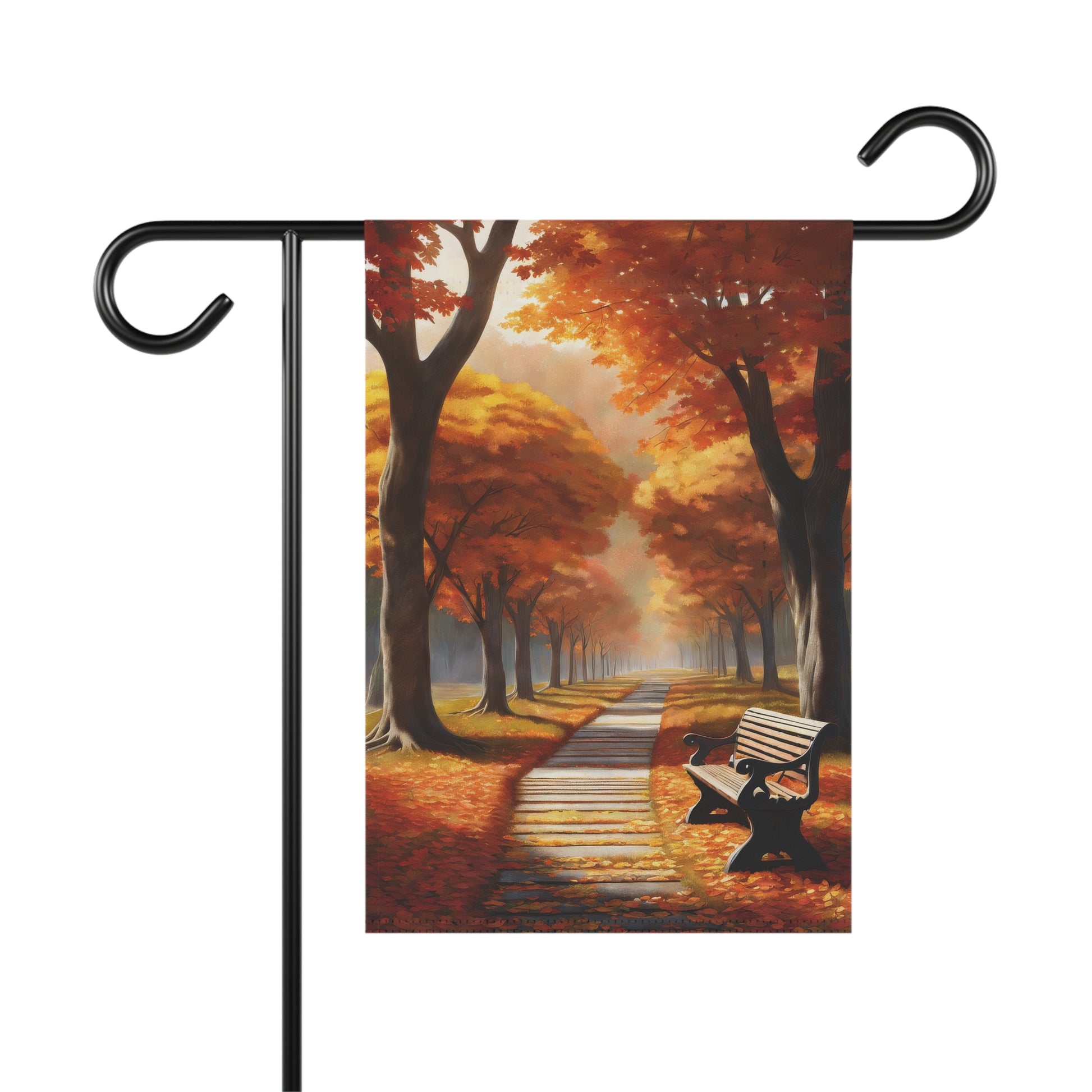 Autumn garden flag depicting a park path lined with bright orange and yellow fall trees, with a dark park bench and fallen leaves on the ground.