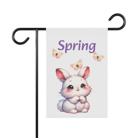 White garden flag displayed on a black metal pole, featuring a cute white cartoon bunny rabbit with rosy cheeks and sparkling eyes, three yellow butterflies, and the word "Spring" in purple script.