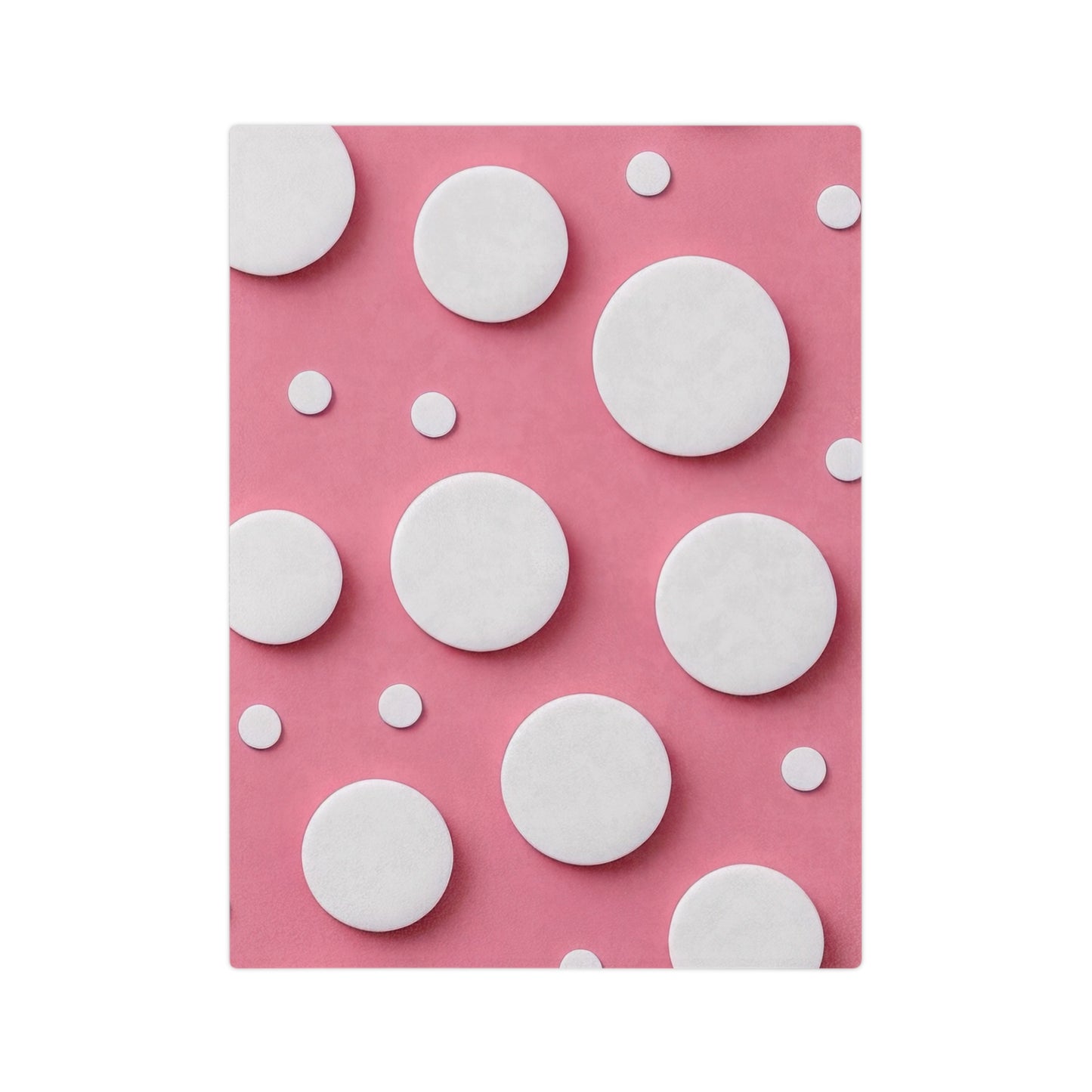 A vibrant velveteen blanket with an abstract polka dot design of various sizes of white circles on a pink background.