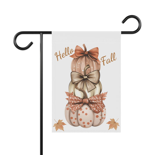 White garden flag featuring a stack of three decorative pumpkins with bows, surrounded by autumn leaves, and the text "Hello Fall"