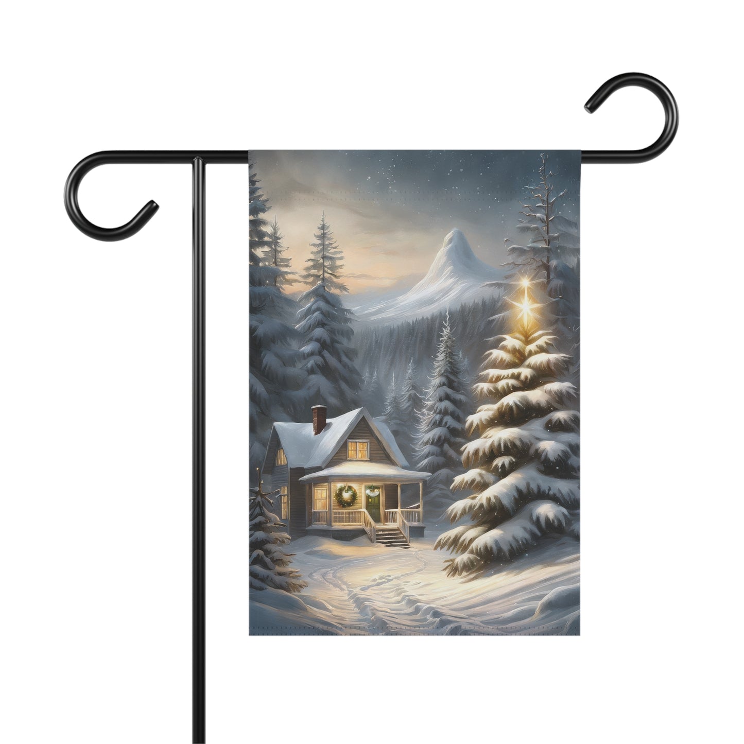 Cozy winter cabin garden flag with a snow-covered house, illuminated Christmas tree, snowy pine trees, and a mountain in the background, on a black metal garden flag stand.