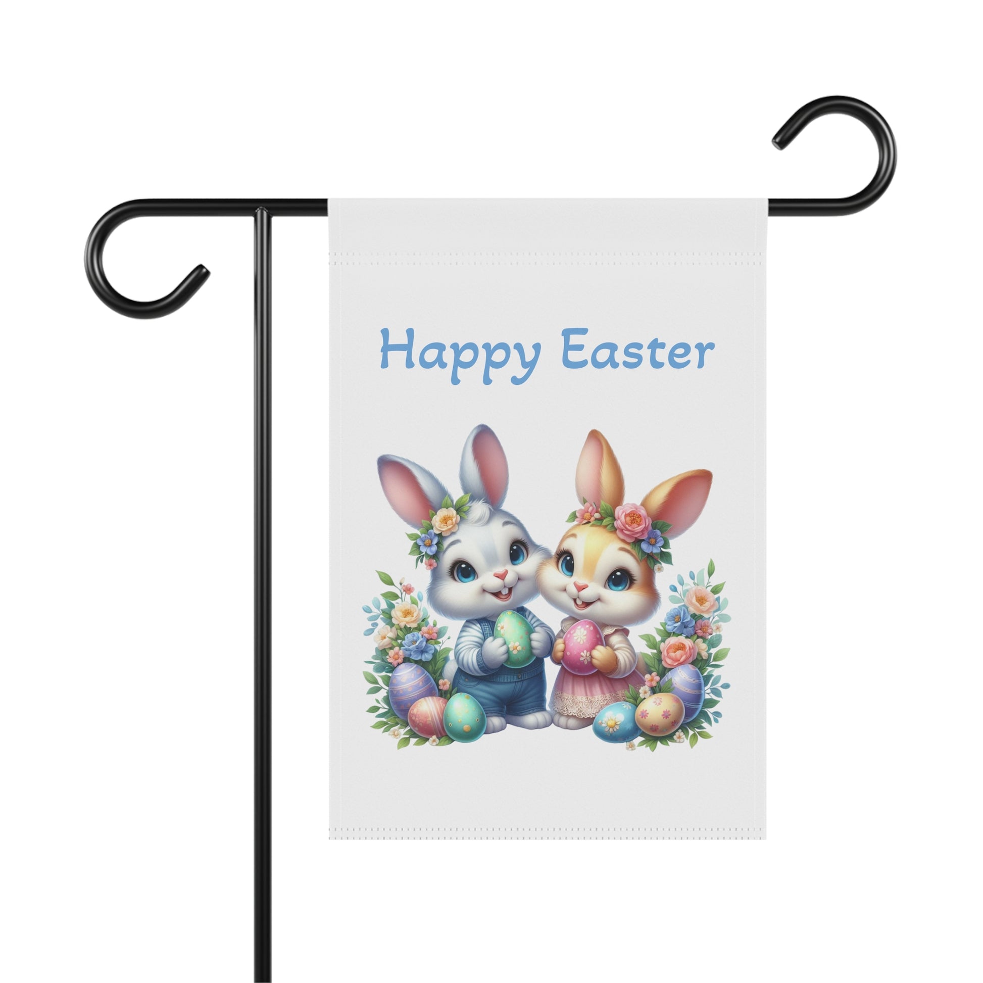 White garden flag with "Happy Easter" in blue text, featuring two cute cartoon bunnies, one blue boy bunny and one orange girl bunny, holding Easter eggs, surrounded by colorful flowers and more painted eggs. The flag is displayed on a black garden flag stand.
