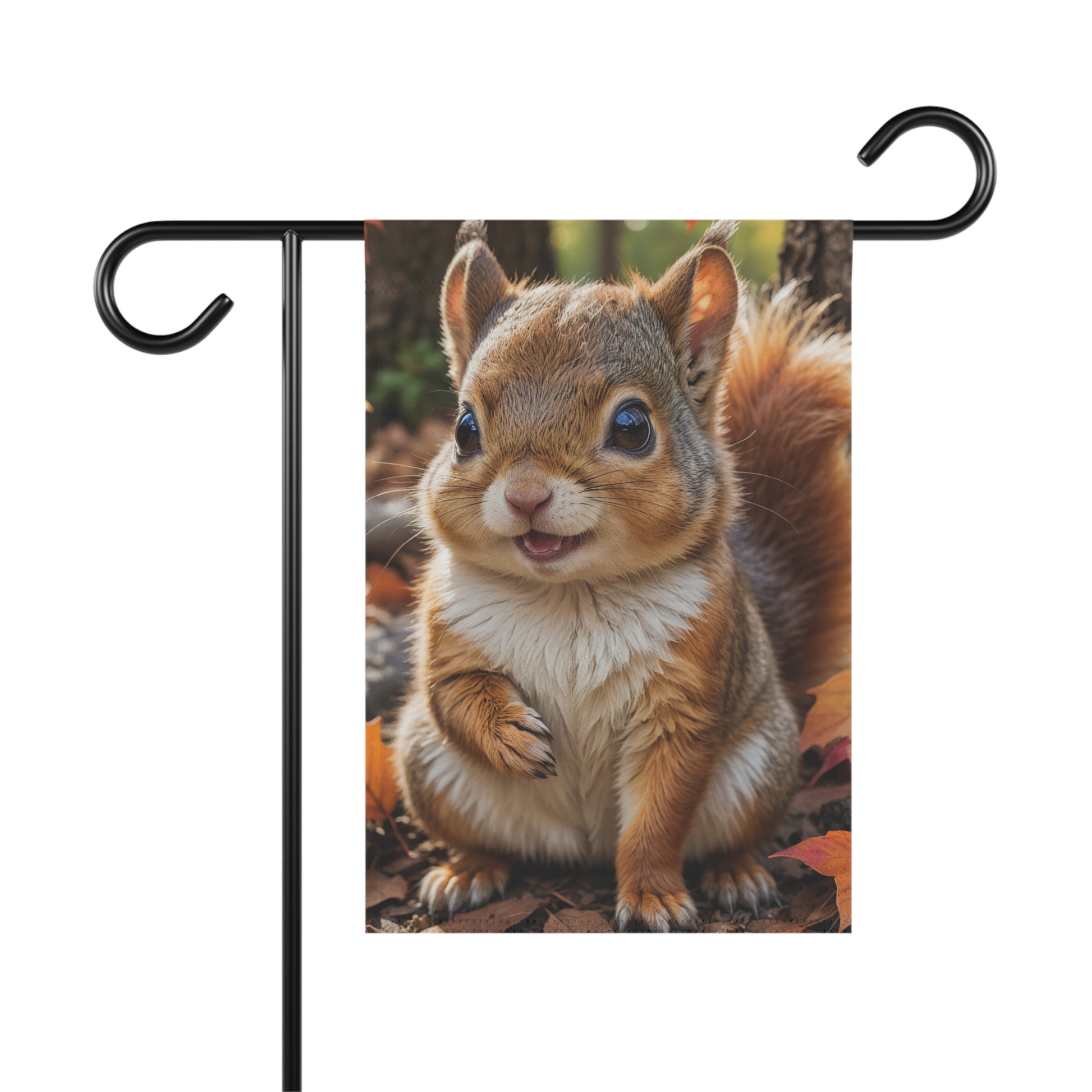 Garden flag with an adorable fluffy baby squirrel with big eyes and a tiny smile, sitting on a bed of fall leaves with a forest background.