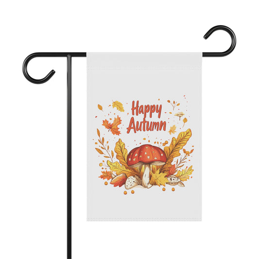 A 'Happy Autumn' garden flag on a metal stand, featuring a whimsical toadstool mushroom surrounded by colorful fall leaves and foliage.