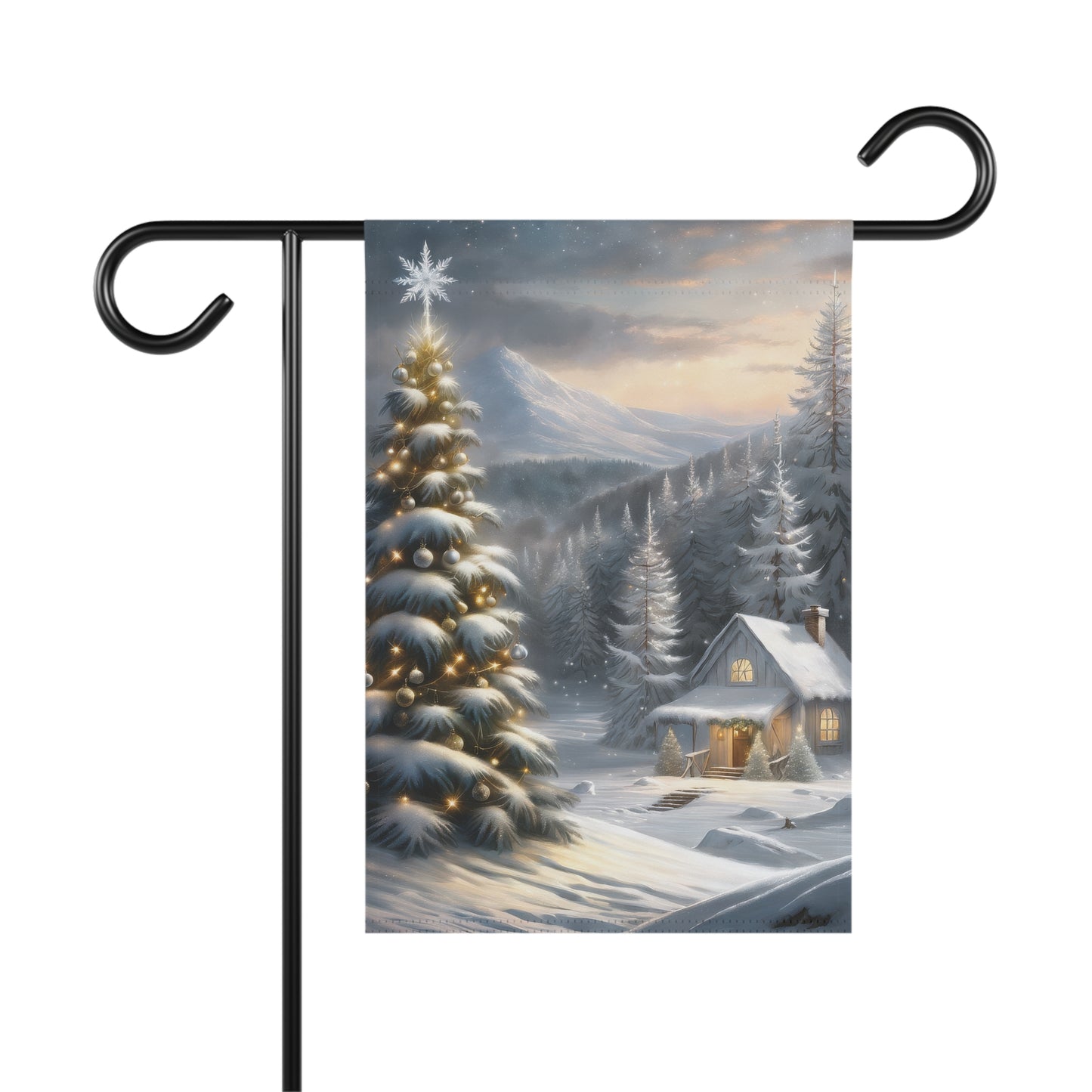 Winter wonderland garden flag with a snow-covered cabin, illuminated Christmas tree with a star, snowy pine trees, and distant mountains, on a black metal garden flag stand.