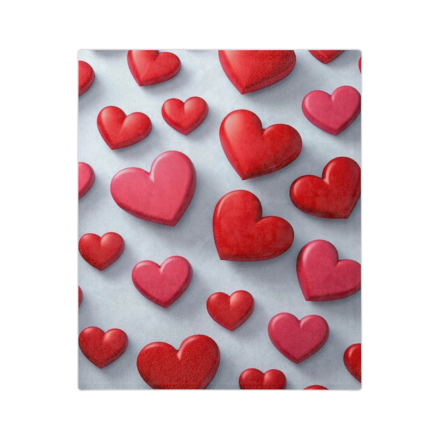 Velveteen blanket with an all-over pattern of various sizes of red hearts on a light blue-grey background.