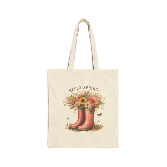 Canvas tote bag with a "Hello Spring" print featuring a pair of pink rain boots filled with a bouquet of flowers.