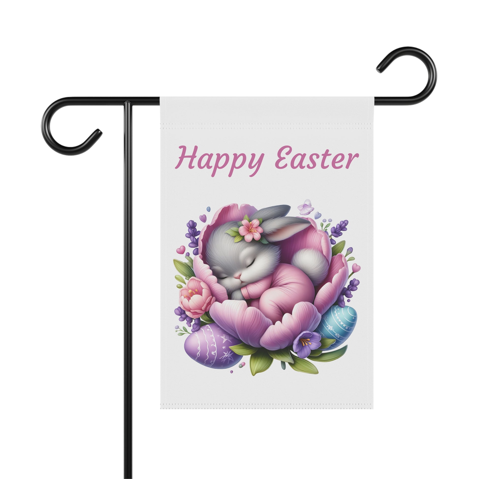 White garden flag with the text "Happy Easter" in pink, featuring a cute gray cartoon bunny sleeping peacefully curled up inside a large purple and pink flower, surrounded by lavender sprigs and colorful patterned Easter eggs. The flag is displayed on a black metal garden flag stand.