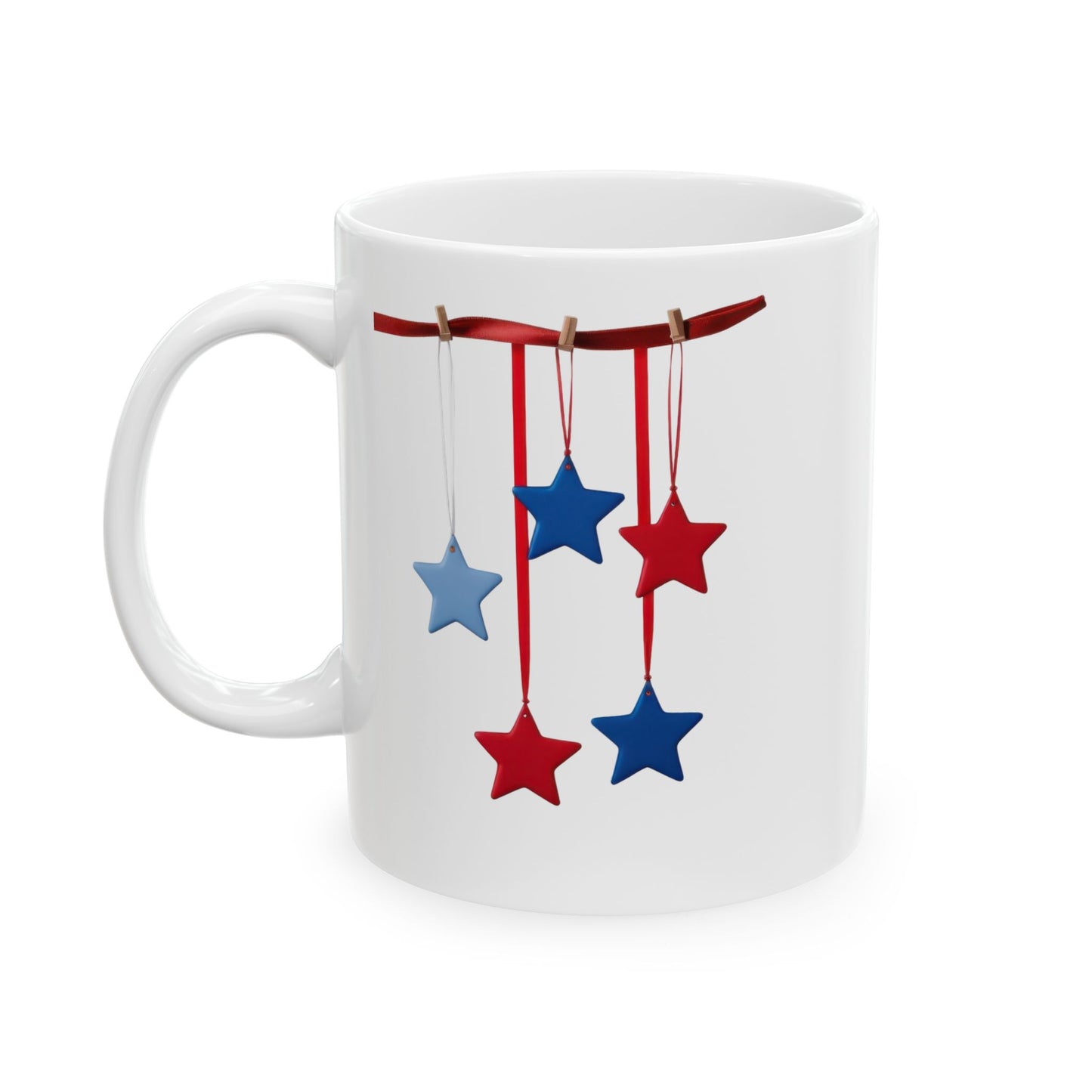 White ceramic coffee mug with a festive patriotic design showing red and blue stars hanging from a red ribbon with small clothespins