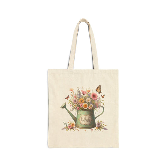 Canvas tote bag with a "Hello Spring" print featuring a vintage watering can filled with flowers and surrounded by butterflies.