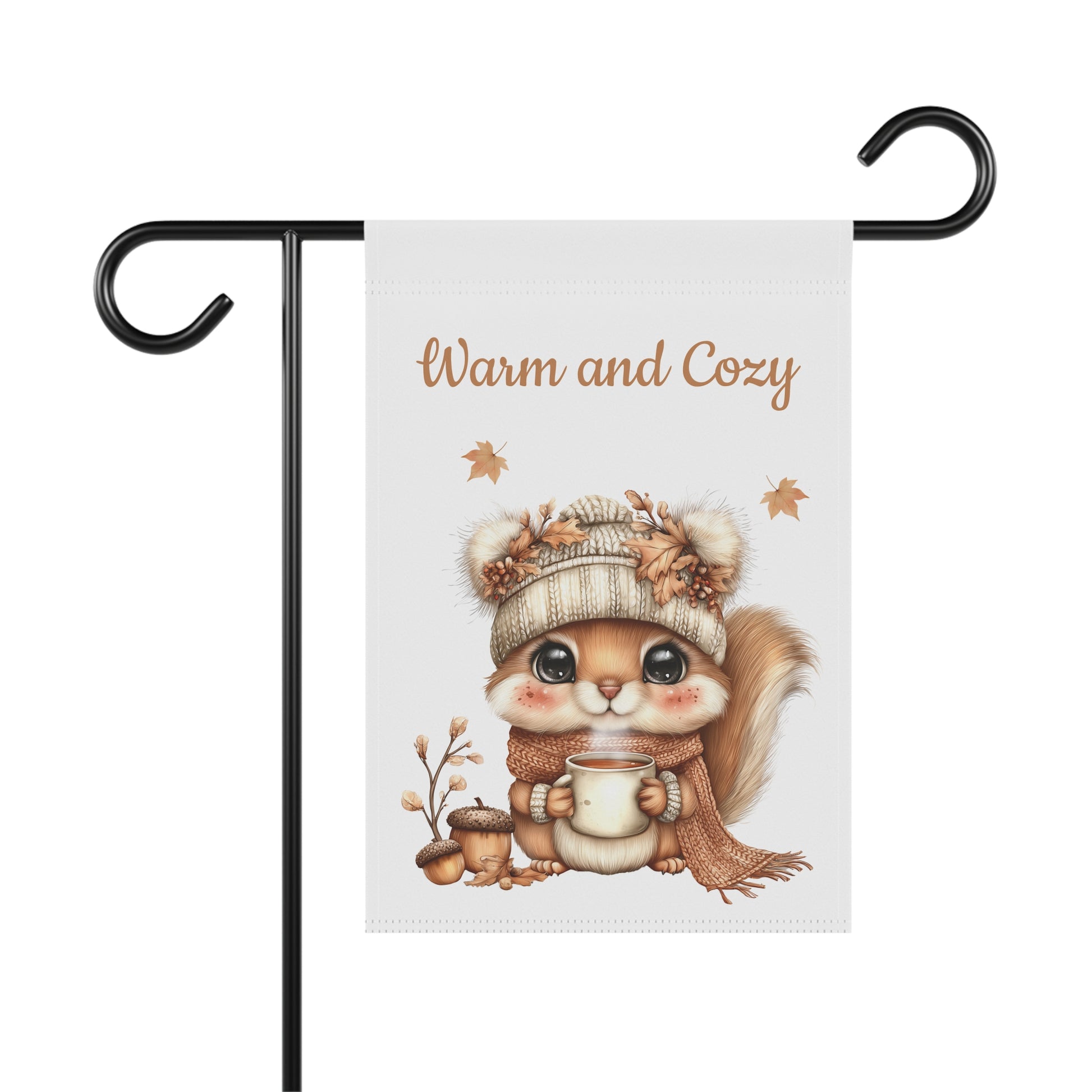 Warm and Cozy garden flag featuring a cute illustration of a baby squirrel wearing a knit winter hat and scarf while holding a steaming mug next to acorns and floating autumn leaves.