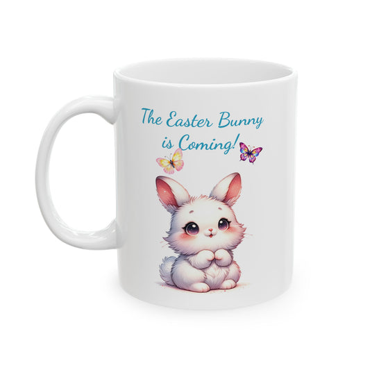 Adorable white ceramic mug with a cute cartoon Easter bunny and colorful butterflies, featuring the text "The Easter Bunny is Coming!"

