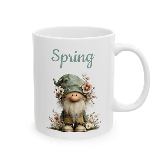 White ceramic coffee mug printed with sage green Spring text above an adorable garden gnome with a flower-adorned hat