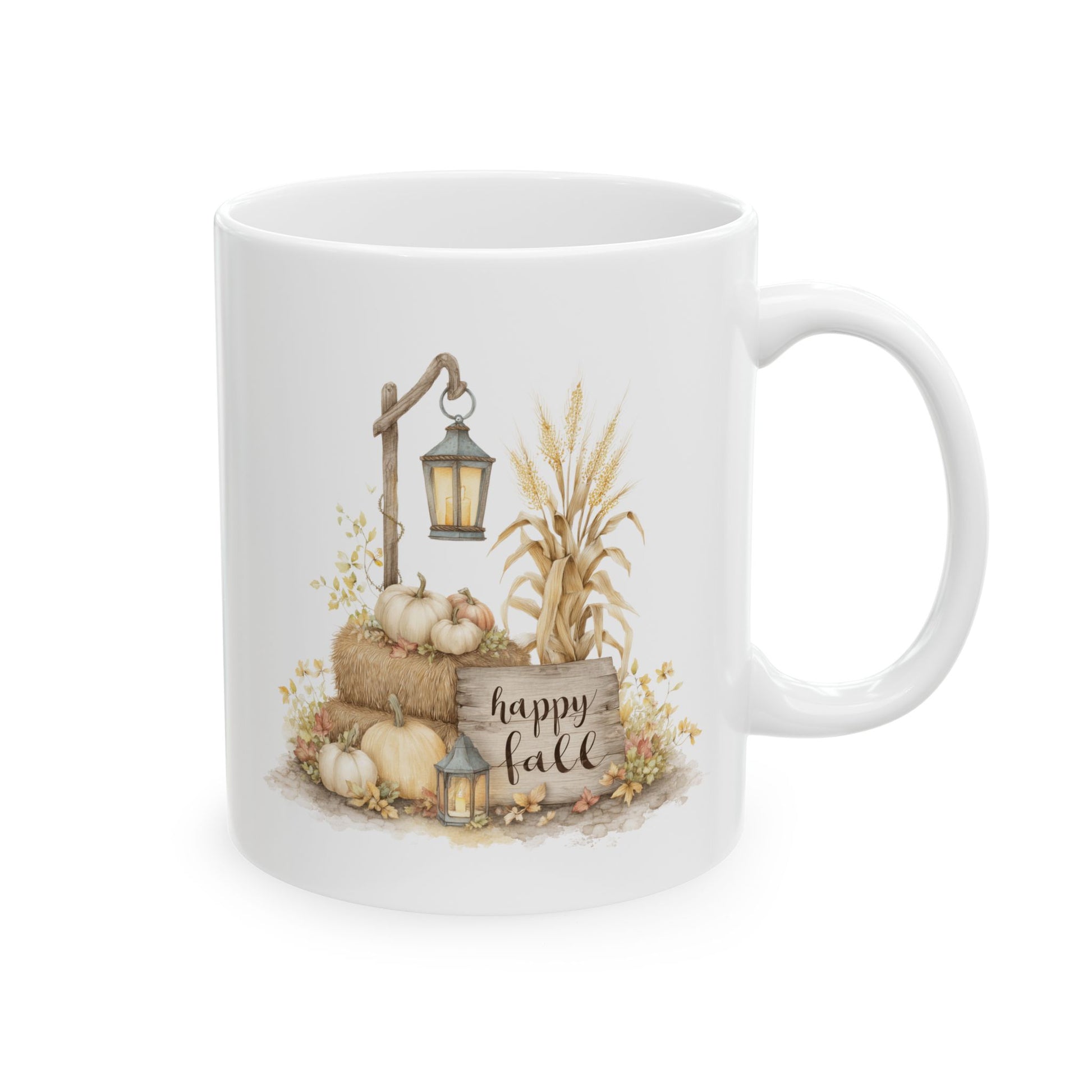 White ceramic coffee mug featuring a watercolor illustration of hay bales, white pumpkins, golden wheat stalks, and glowing vintage lanterns next to a rustic wooden sign that reads happy fall.