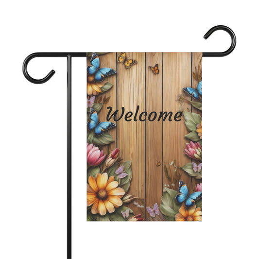 Welcome garden flag with butterflies and flowers on rustic wood background, spring yard decor with floral border and vibrant colors