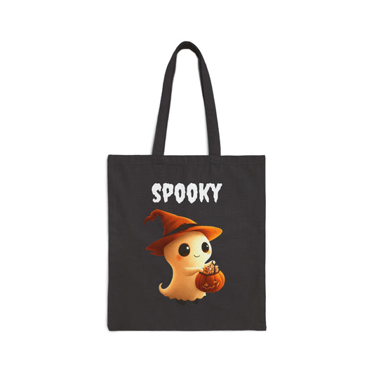 A black 100% cotton canvas tote bag featuring a cute illustration of a ghost with a pumpkin, wearing a witch's hat. The word "SPOOKY" is printed in white above the ghost.