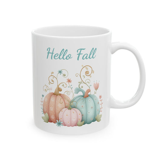 White ceramic coffee mug featuring a bohemian watercolor illustration of three patterned pastel pumpkins in peach, pink, and teal with swirl doodles under the words Hello Fall.