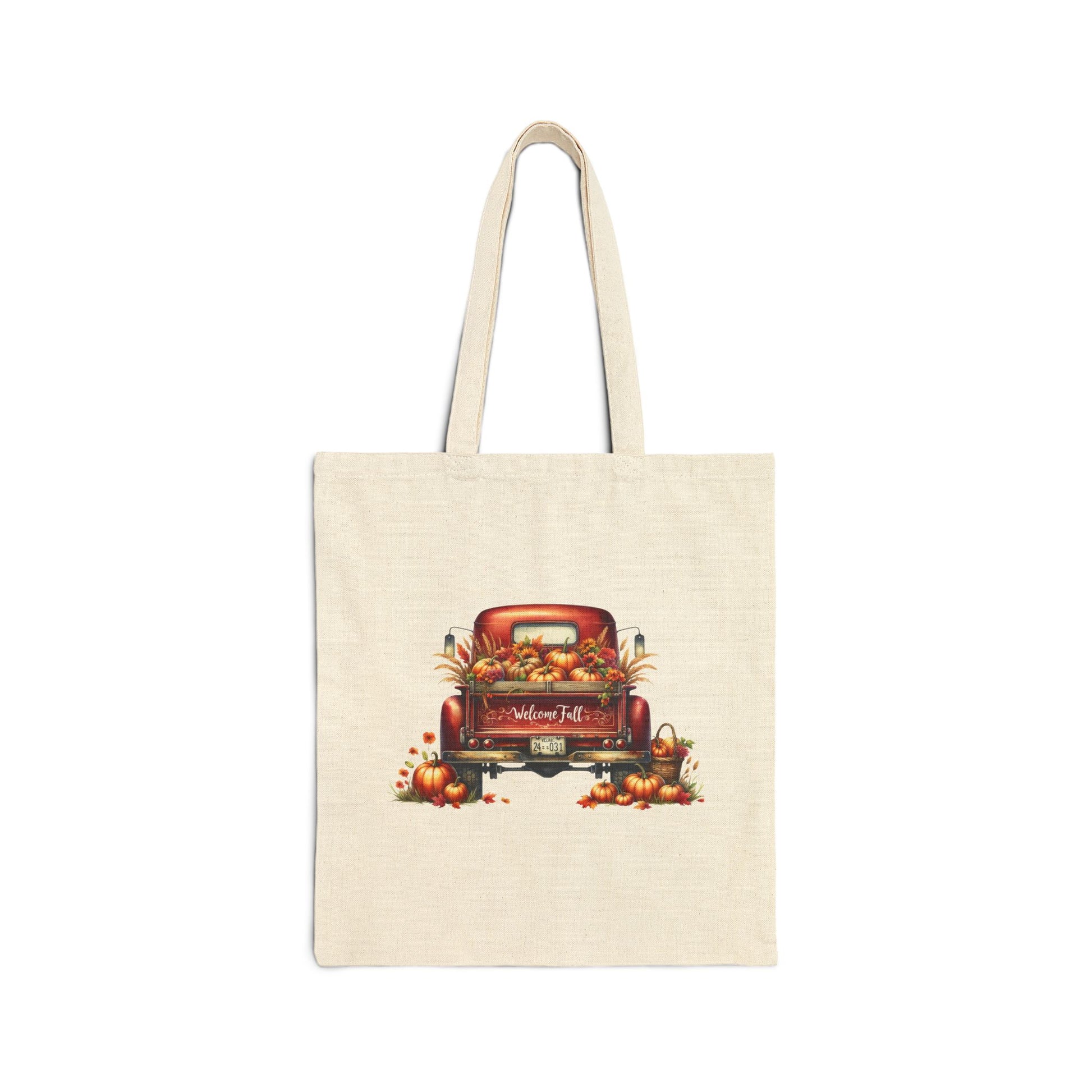Cream-colored canvas tote bag with a vintage red truck filled with pumpkins and fall leaves

