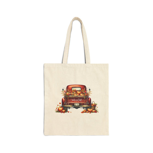 Cream-colored canvas tote bag with a vintage red truck filled with pumpkins and fall leaves

