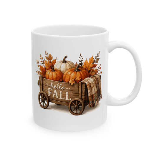 White ceramic mug featuring autumn harvest wagon illustration with white lettering reading Hello Fall.
