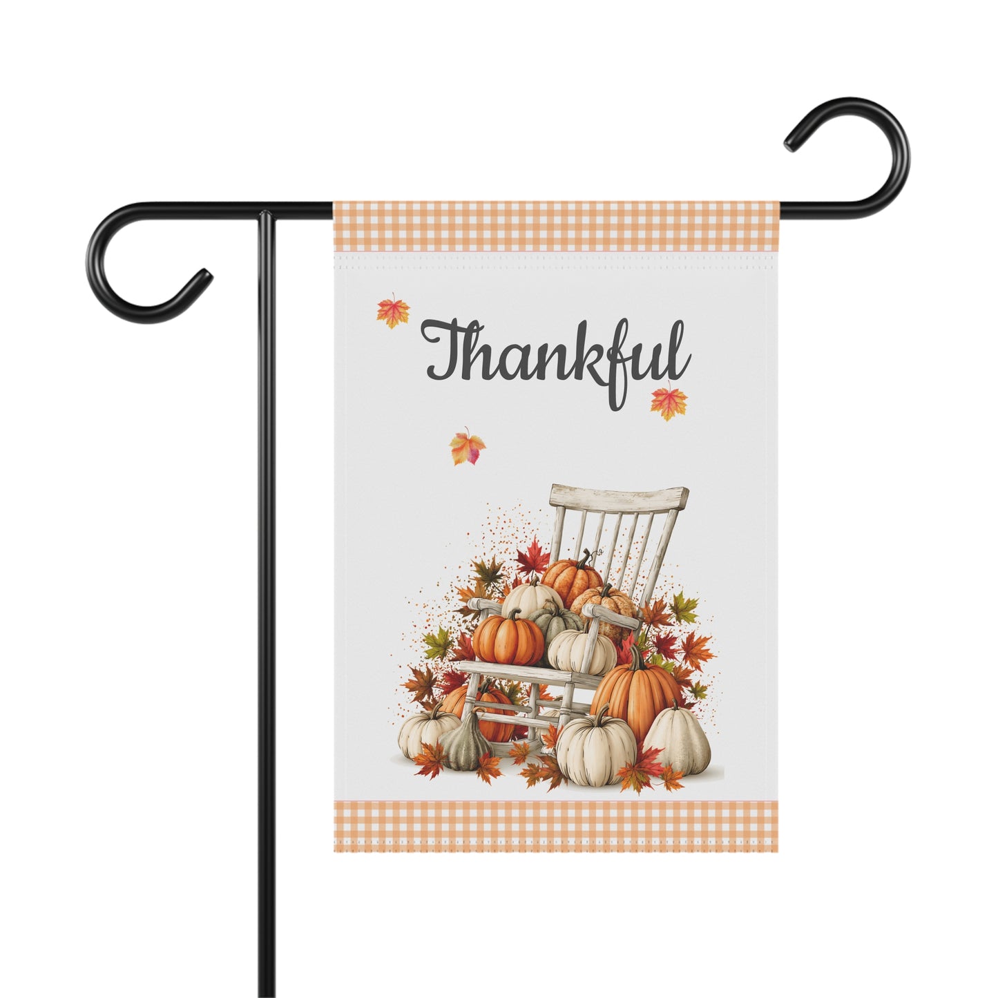 Outdoor garden flag featuring a rustic rocking chair piled with pumpkins and autumn leaves beneath text reading Thankful with orange gingham borders.
