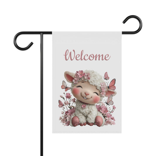 Spring garden flag featuring a happy smiling white lamb wearing a flower crown surrounded by pink butterflies and cherry blossoms under pink script text reading Welcome.