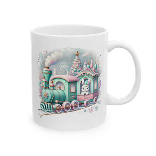 White ceramic coffee mug printed with a pastel mint green and pink Christmas express train featuring a cute bunny passenger and pastel decorated tree