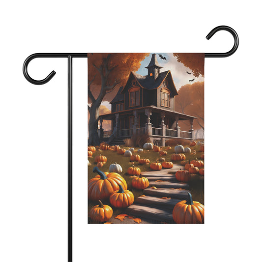 Garden flag depicting a house with a porch, surrounded by a large pumpkin patch with a path leading up to it, under an autumn sky with flying bats. Trees with orange leaves are in the background. 