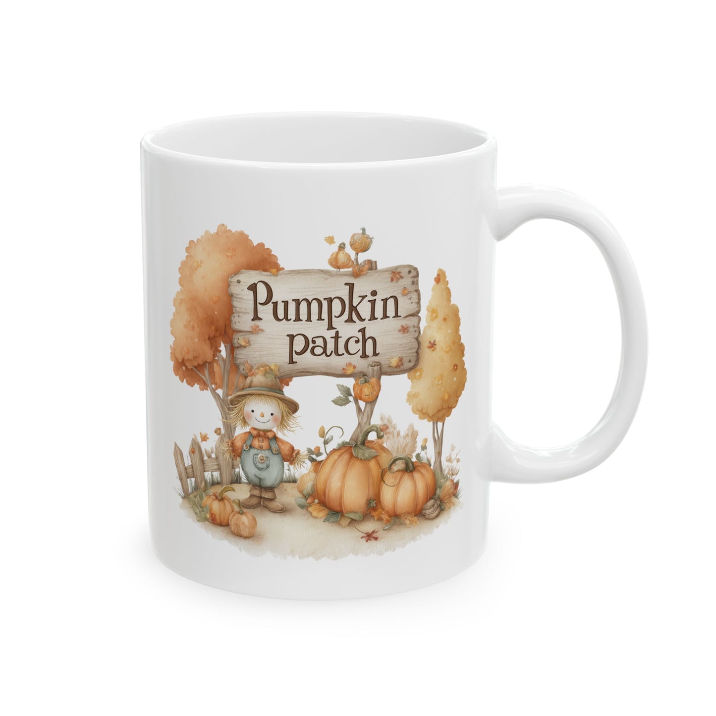 White ceramic coffee mug featuring a soft watercolor illustration of a cute little scarecrow in overalls, pumpkins, and autumn trees next to a wooden sign that reads Pumpkin patch.