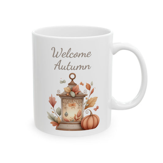 White ceramic mug featuring autumn vintage lantern illustration beneath soft brown script text reading Welcome Autumn.