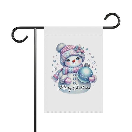 Cute cartoon snowman garden flag wearing a pink and blue hat and scarf, holding a blue Christmas ornament, with "Merry Christmas" text and snowflakes, festive outdoor decor.

