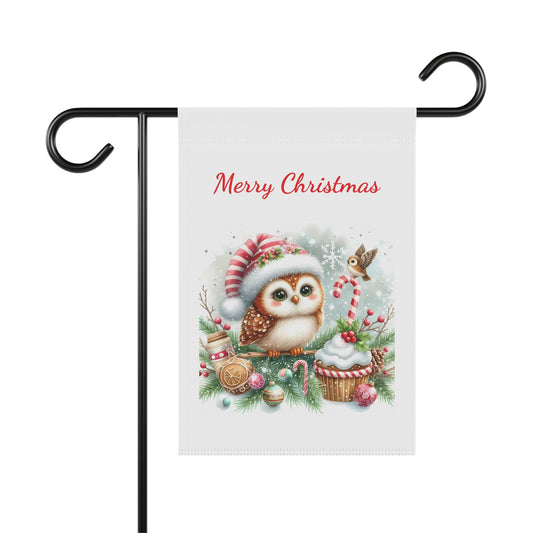 A 'Merry Christmas' garden flag on a metal stand, featuring a cute, big-eyed owl wearing a Santa hat surrounded by festive holiday items.