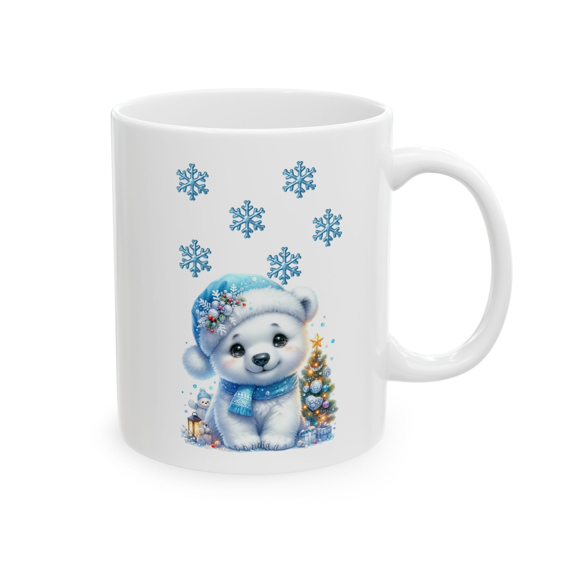 White ceramic coffee mug with a watercolor illustration of a cute baby polar bear in a blue winter hat and scarf, sitting next to a decorated Christmas tree with blue snowflakes falling.