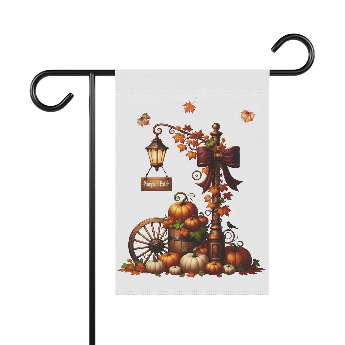 Whimsical autumn garden flag featuring a vintage lamppost with a glowing lantern and a large red bow, a Pumpkin Patch sign, a wooden wagon wheel, and an arrangement of orange and white pumpkins.