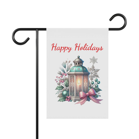 Happy Holidays garden flag with an antique lantern glowing, surrounded by winter berries, evergreens, snowflakes, and a pink bow, festive outdoor decor.

