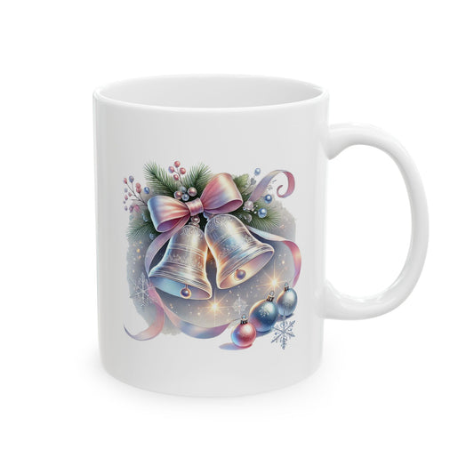 White ceramic coffee mug printed with an illustration of two silver Christmas bells adorned with a pastel pink bow, pine branches, and ornaments
