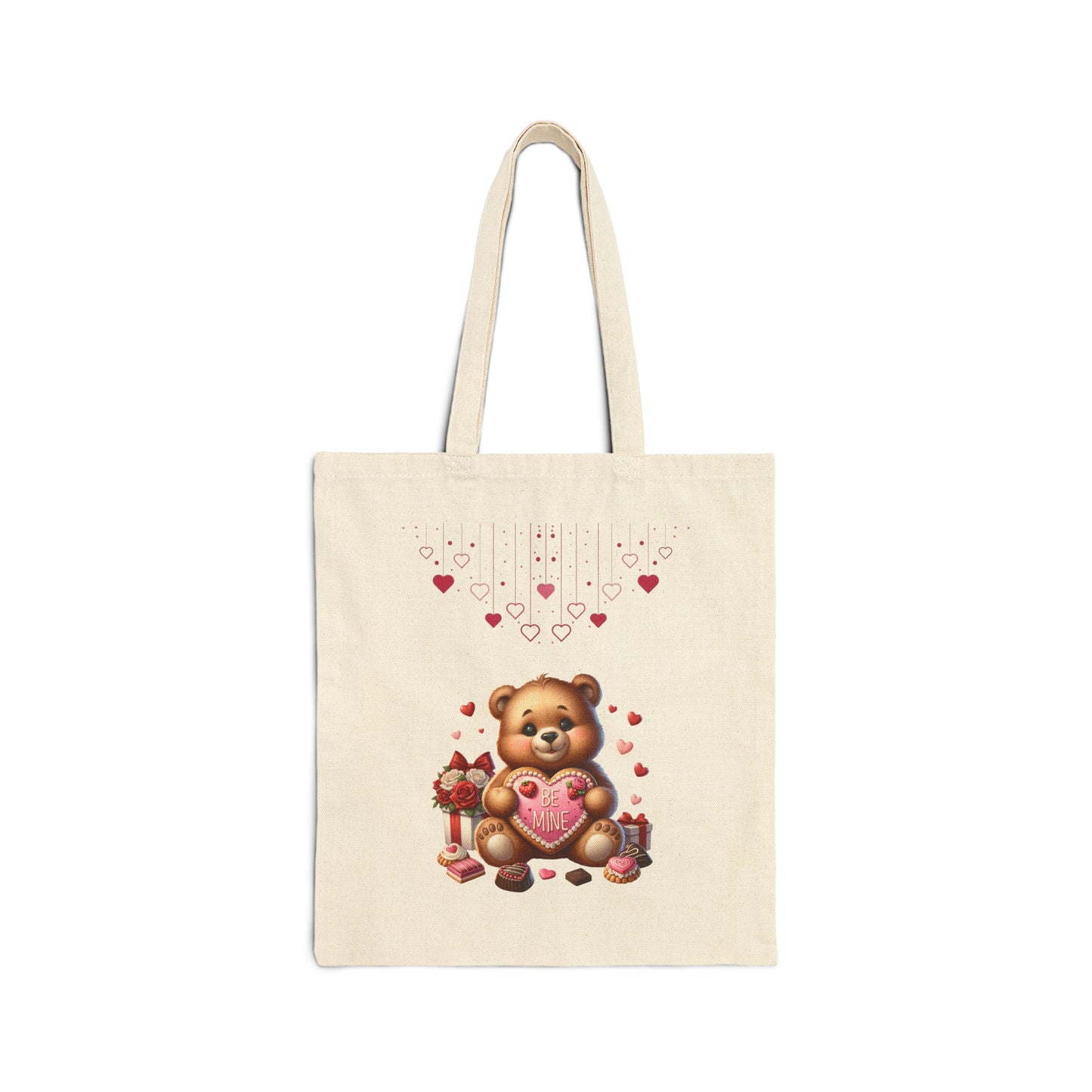 A natural canvas tote bag featuring a cute teddy bear holding a "BE MINE" heart, with small hearts floating above.
