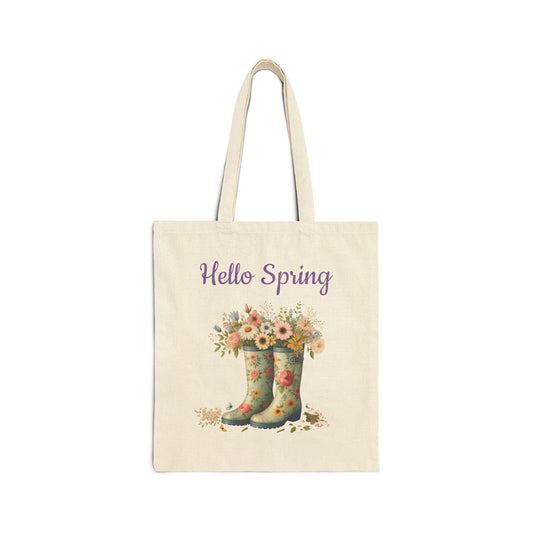 Canvas tote bag with a "Hello Spring" print featuring a pair of floral rain boots filled with wildflowers.