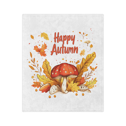 White velveteen blanket with a watercolor illustration of a red-capped mushroom surrounded by orange and yellow autumn leaves and acorns, with the words "Happy Autumn" in red text.

