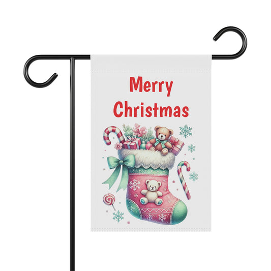 Merry Christmas garden flag with a pink and green stocking overflowing with gifts like teddy bears and candy canes, surrounded by snowflakes, festive holiday outdoor decor.

