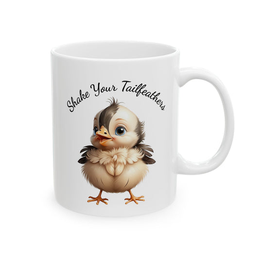 White ceramic coffee mug with a cartoon chick illustration and "Shake Your Tailfeathers" text