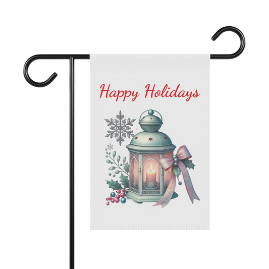 Happy Holidays garden flag with a glowing vintage lantern, surrounded by winter berries, green foliage, snowflakes, and a pink and gold bow, festive outdoor decor.


