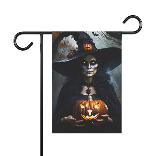 Halloween garden flag with spooky witch holding a glowing jack-o'-lantern in dark forest