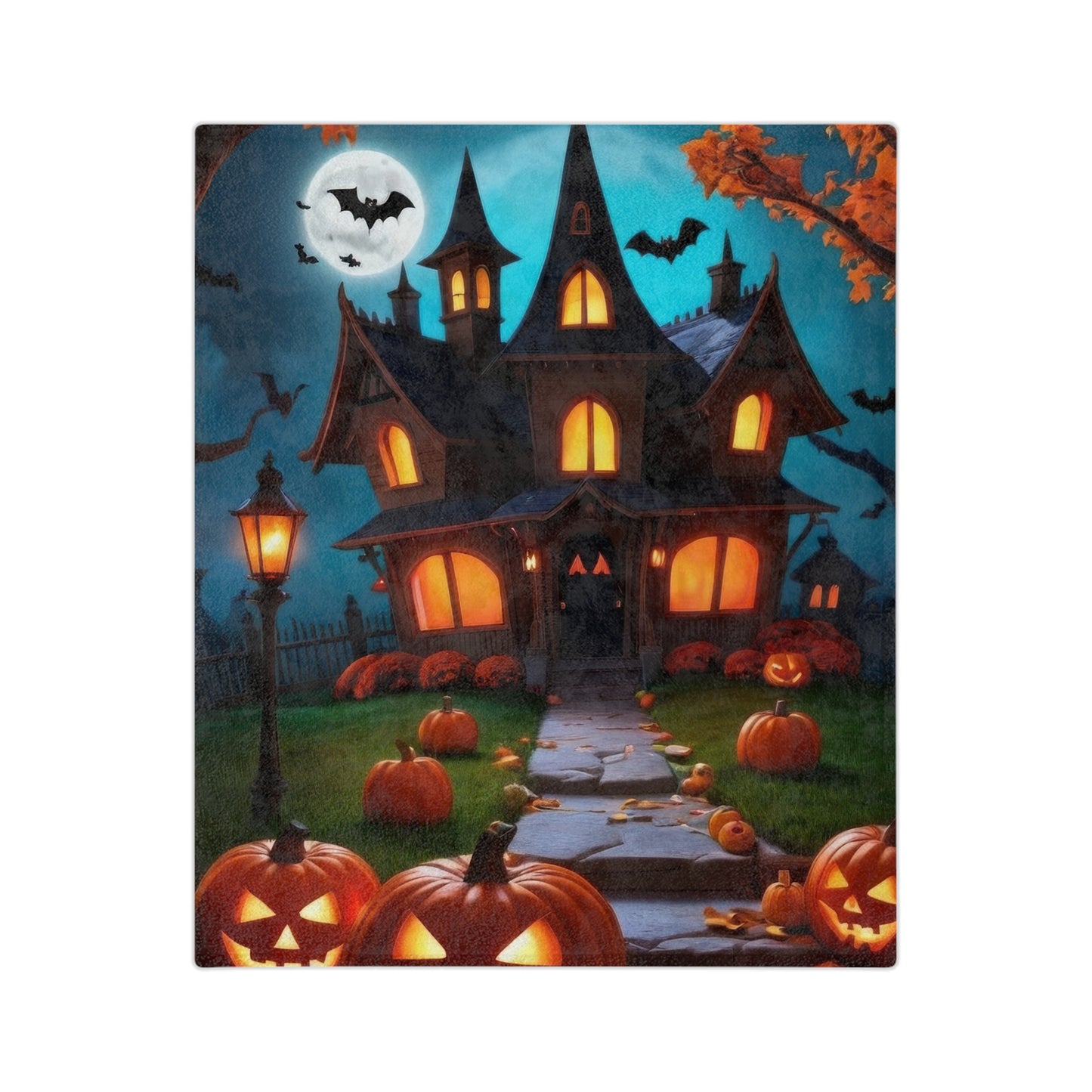 Lightweight velveteen throw blanket with a Halloween print featuring a brightly lit haunted house, many jack-o'-lanterns, a street lamp, bats, and a full moon.