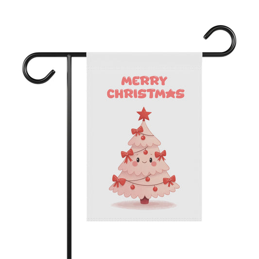 A 'Merry Christmas' garden flag on a metal stand, featuring a cute, smiling pink Christmas tree with red bows and a star.
